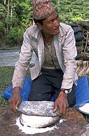 Nepali herder making breakfast chapatis along the Sali Khola, Nepal.