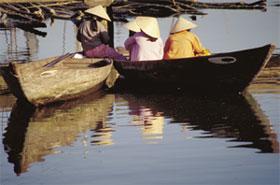 Small boats on the bank of the Thu Bon River. From the 17th to the 19th centuries Hoi An was among the most active ports in Southeast Asia. Today, fishing boats still go down the Thu Bon River to the South China Sea for their catch.