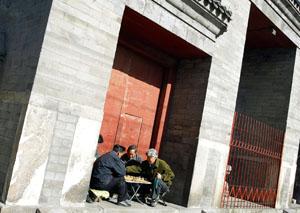 Beijing residents play chequers in a doorway in Hutong. Beijing's Hutongs date back to the 12th century and are a labyrinth of brick houses with walled courtyards.