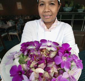 A Thai chef shows an orchid salad made with flowers at a restaurant at the Rose Garden resort in Nakhon Pathom province.