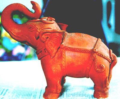 This fine terracotta elephant stands to attention among many unique example by one of the islands younger potters.
