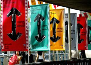 Thais walk past rows of banners and signs advertising the Bangkok International Film Festival.