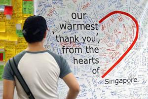 A man reads messages by Singaporeans' thanking health-care workers caring for SARS patients. Over 1,200 handwritten messages of gratitute and encouragement were displayed in this subway station.
