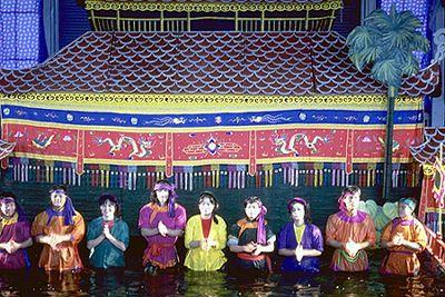 The puppeteers line up in front of the screen at the end of the performance.