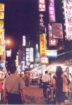 Friends and families enjoy shopping and eating at the night market.