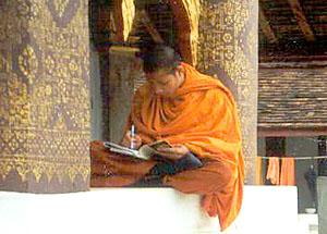 A monk at Luang Prabang's Wat Saen bundles up on a cold February day.