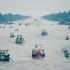 Boats laden with goods make their way down a canal in the Mekong Delta, one of seven such canals that meet near the town of Phung Hiep.