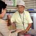 Seventy-eight-year-old fortune-teller Terutsugu Eguma attends to a customer on the street of Ginza shopping district of Tokyo.