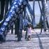 A young girl plays in the skeins of traditional blue and white tie-died fabric as they dry in a courtyard.