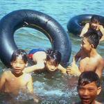 Boys swimming in the Perfume River