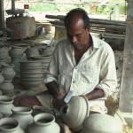 Supported from the inside the pot is slapped rhythmically with a small wooden paddle.