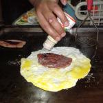 Put the meat on the egg; add a dash of pepper