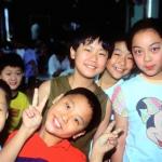 Kids at the Children's Palace send a pointed gesture of greeting. Shanghai, China.