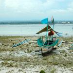 Philippines, Mindanao, Samal Island, banca on beach.
