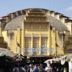 Exterior of Central Market, Phnom Penh, Cambodia. The yellow Art Deco style cavernous building seems incongruous and alien to its surroundings.