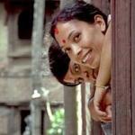 Two women leaning out of a window, Kathmandu, Nepal.
