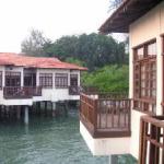 Rooms situated on finger piers over the Straits of Malacca.