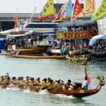 A dragon boat crew give their all as they paddle to the beat of the drum as they approach the finish line in the dragon boat races on Lamma Island, Hong Kong, 16 April 2001. The dragon boat races are an annual event and this year was won by a local crew under the banner of Esso.