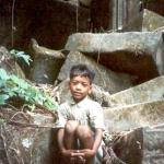 A young boy rests on some of the ruins at Beng Mealea, Siem Reap, Cambodia.