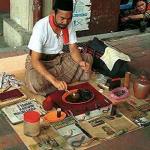 Bomoh or Malay folk healer at a street market in Kuala Lumpur as above.