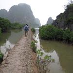 Sally and Rosie, walking across the mud dams to Dong Cong island, Vietnam.