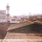 Bombay, India. From the rooftop of a flat in Dongri can be seen the communities' mosques, as well as the distant high-rises of Bombay.