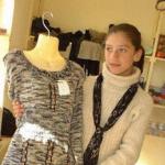 Salesgirl Salma Salat shows one of the outfits for sale at her shop in the Women's Bazaar or Bazaar-e-Zanana in Kabul.