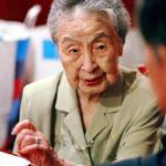 Hideko Arima, 101-year-old bar proprietress, deals with a customer at her tiny bar Gilbey-A in Tokyo's glitzy Ginza district.