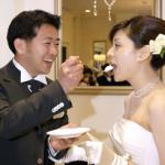 Yuichi Nakasho feeding a piece of cake to his bride, Yuko Sasakawa, during their wedding reception at a wedding hall in Tokyo.