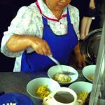 Before the rich curry mixture is added a spoonful of thick coconut milk is poured over the noodles.