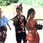 Ban Chang, Thailand: Students carry their kratongs to float them in a nearby pond.