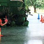 Ban Chang, Thailand. Two students perform traditional dance to celebrate Loy Kratong. In their left hands they hold a lotus flower containing a candle.