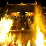 Incense and candles blaze as pilgrims watch during the New Year's celebrations at Longhua Temple in Shanghai, China. The Chinese celebrate New Year by ringing a bell, burning incense, and praying at a temple, to bring good luck and happiness.
