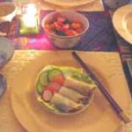 Rice paper wrapped spring rolls with a side dish of crunchy cucumber, carrot and radish pickles.