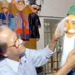 Bangladeshi artist Mostafa Monawar, known as the 'puppet man' puts the final touches to a puppet in Dhaka.