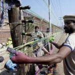 A professional prepares special thread used in kite flying on a roadside pavement on the eve of the annual kite-flying festival, locally known as 'Basant', in the eastern city of Lahore, 07 February 2003. Basant is celebrated at the onset of each spring with an orgy of kite-flying, roof top soirees, garden parties and equestrian events.