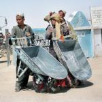 Young Pakistani labours wait for customers at the old border gate between Pakistan and Afghanistan in Chaman. A new gate named Gate of Friendship, a new border post linking south-west Pakistan with south-east Afghanistan was founded 300 meters further away towards Afghanistan than the previous one. The Pakistani authorities said they only returned to the Durand Line border abandonned after the Soviet invasion of Afghanistan, but the Afghan population claim it has been build inside Afghanistan.