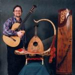 Musicologist Rick Heizman with some of his favorite musical instruments: In the center is a Burmese saung gauk, behind it is a Middle Eastern oud from Syria, on the right is a Chinese zheng.