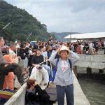 Suratthani, Thailand. Suratthani is the coastal town from which ferries to the Samui archipelago embark. A tourist horde looks on as a ferry tries to dock, or, having docked, unloads its cargo.