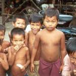 Children near Phnom Sampeau gather for a balloon giveaway.