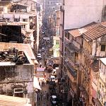 Bombay, India. Though it is formally restricted to a peninsula as diminutive as Manhattan, Bombay is simply massive. Western cities tend to rise; Bombay grows more dense. Everywhere sprout more shanties, rundown colorful corridors, turns and fly-overs, chowks and bridges. The growth is disorderly and immense.