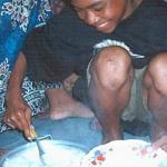 Lyna dishes up a big plate of rice for dinner.