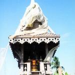 A spirit house's design and the materials used in its construction vary. Some are simple shelters built from wood and metal, like this one. More commonly, they are huge, elaborate, multi-colored cement structures formed in factories.