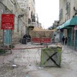 Palestianian schoolchildren pass a checkpoint on their way to school in Hebron.