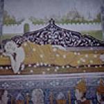 One of the many scenes from the Buddha's life painted on the inner wall of the main temple of Wat Pharathat, this depicts the Buddha undergoing "brinippan", a word of Sanskrit origin meaning "to die to the world". The word can only be used of the Buddha.