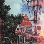 This sign for a Chiang Mai restaurant shows the word 'coca' transliterated into Thai. The four characters are, from left to right, o-k-k-ah; but, because of Thai's placement of vowels, it is read 'kokah.' Transliterations are common for loan words; 'download', for example, is 'daonlot', with a mark over the 'n' to make it silent.