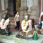 Buddha images at Haw Phra Kaew are adorned with garlands of flowers.
