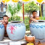 Young monks at a Vientiane temple distribute holy water to the faithful.