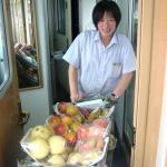 The fruit lady making her way down the aisle.