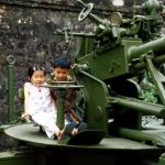 Children play on anti-aircraft gun at the Army Museum.